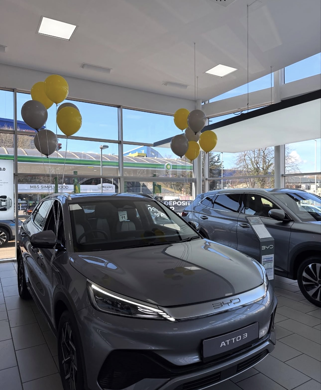 Customer celebrating with bouquet and BYD vehicle